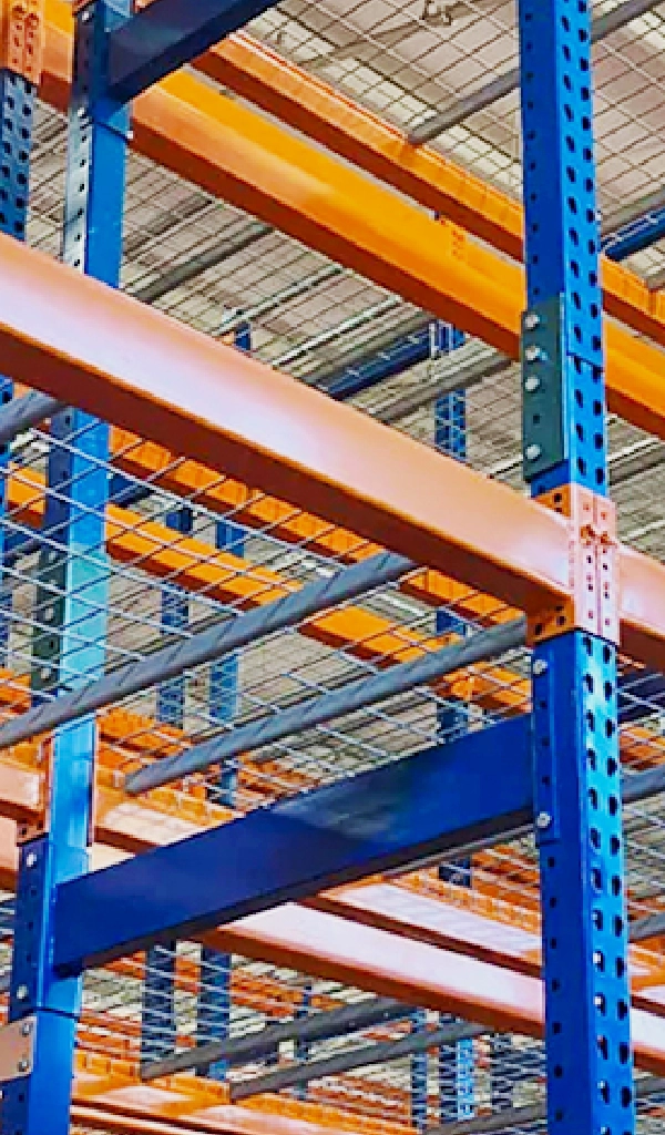 Blue and orange Warehouse Storage Rack Systems with wire mesh shelves, viewed from below at an angle, showcase durable and efficient warehouse organization.
